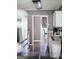 Kitchen with stainless steel appliances, white cabinetry, and an eat-in dining area with wood flooring at 401 N Lost Lake Cv, Villa Rica, GA 30180