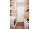 Functional laundry room with a washer, dryer, and storage shelving at 401 N Lost Lake Cv, Villa Rica, GA 30180