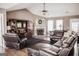 Spacious living room with leather furniture, a fireplace, and plenty of natural light at 401 N Lost Lake Cv, Villa Rica, GA 30180