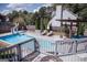 Inviting pool area with lounge chairs, a pergola, and a slide for added fun in the sun at 401 N Lost Lake Cv, Villa Rica, GA 30180