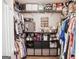 Well-organized walk-in closet with custom shelves and ample storage space for all wardrobes at 401 N Lost Lake Cv, Villa Rica, GA 30180
