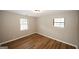 Cozy bedroom with wood-look flooring, neutral paint, and natural light creating a relaxing space for rest and rejuvenation at 500 Carillon Ct, Stone Mountain, GA 30083