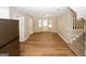Inviting dining room leading to the kitchen, featuring wood-look flooring, neutral walls, and staircase access for seamless living at 500 Carillon Ct, Stone Mountain, GA 30083