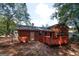 Backyard view of home with wooden deck at 500 Carillon Ct, Stone Mountain, GA 30083