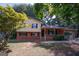 Charming two-story home featuring a well-maintained lawn, brick accents, and attached garage, perfect for suburban living at 500 Carillon Ct, Stone Mountain, GA 30083