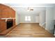 Bright and airy living room featuring wood-look flooring, a fireplace, and access to the staircase and other living spaces at 500 Carillon Ct, Stone Mountain, GA 30083