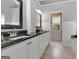 Bathroom features double sinks, granite countertop, and updated fixtures at 145 Driftwood Trl, Fayetteville, GA 30215