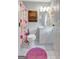 Bathroom with a floral shower curtain and decorative wooden shelves at 145 Driftwood Trl, Fayetteville, GA 30215