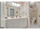 Well-lit bathroom with double sinks and a doorway view to the toilet at 145 Driftwood Trl, Fayetteville, GA 30215
