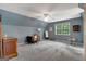 Blue bedroom with sloped ceilings, carpet, and a desk area by the window at 145 Driftwood Trl, Fayetteville, GA 30215