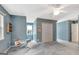 Blue bedroom featuring a ceiling fan, closet and light filled windows at 145 Driftwood Trl, Fayetteville, GA 30215