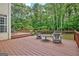 Large outdoor deck with patio furniture, perfect for relaxing and entertaining while enjoying the serene backyard at 145 Driftwood Trl, Fayetteville, GA 30215