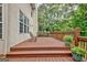 Outdoor deck with seating, potted plants, and a serene view of the surrounding greenery at 145 Driftwood Trl, Fayetteville, GA 30215