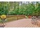 Spacious wood deck with seating, offering a peaceful view of the surrounding wooded landscape at 145 Driftwood Trl, Fayetteville, GA 30215