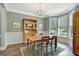 Charming dining room with wainscoting, chandelier, and large windows providing abundant natural light at 145 Driftwood Trl, Fayetteville, GA 30215