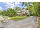Two-story brick home with a front porch, shuttered windows, and a driveway leading to the side of the house at 145 Driftwood Trl, Fayetteville, GA 30215