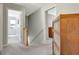 Upstairs hallway with hardwood floors and doors leading to various rooms at 145 Driftwood Trl, Fayetteville, GA 30215