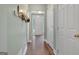 Hallway with hardwood floors offers convenient access to various rooms and a bright view of the front entrance at 145 Driftwood Trl, Fayetteville, GA 30215