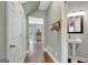Hallway with hardwood floors and access to a powder room and exterior door at 145 Driftwood Trl, Fayetteville, GA 30215