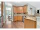 Well-lit kitchen boasting granite countertops, stainless steel appliances, and wood cabinetry at 145 Driftwood Trl, Fayetteville, GA 30215