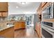 The kitchen boasts granite countertops and stainless steel appliances with hardwood floors at 145 Driftwood Trl, Fayetteville, GA 30215