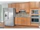 This spacious kitchen features stainless steel appliances and wooden cabinetry at 145 Driftwood Trl, Fayetteville, GA 30215