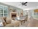 Bright living room with fireplace, hardwood floors, and a seamless flow to the dining area at 145 Driftwood Trl, Fayetteville, GA 30215