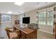 Finished basement office features a wooden desk, recessed lights, and a pair of large windows at 145 Driftwood Trl, Fayetteville, GA 30215