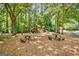 Community playground area featuring multiple slides, swings, picnic tables and a cushioned play surface at 145 Driftwood Trl, Fayetteville, GA 30215