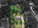 Aerial view of a large property with lush greenery surrounding a two-story home, highlighted in color at 416 River Forest Dr, Mcdonough, GA 30252