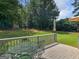 Wood deck featuring a metal table with seating, overlooking the spacious backyard and green lawn at 416 River Forest Dr, Mcdonough, GA 30252