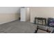 Neutral toned basement features gray carpet, beige walls, and an open doorway leading to additional space at 416 River Forest Dr, Mcdonough, GA 30252