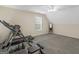 Neutral-toned basement includes a window and houses fitness equipment at 416 River Forest Dr, Mcdonough, GA 30252