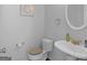 Powder room with decorative mirror, pedestal sink, and neutral decor exudes simple, classic charm at 416 River Forest Dr, Mcdonough, GA 30252