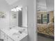 Bright, updated bathroom with double vanity and mirrors, with a view to the shower and bedroom at 416 River Forest Dr, Mcdonough, GA 30252