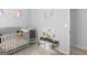 This sweet Bedroom has a gray crib and is accented by a play kitchen at 416 River Forest Dr, Mcdonough, GA 30252