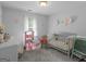Adorable Bedroom with a crib, playful decor, and light gray walls at 416 River Forest Dr, Mcdonough, GA 30252