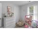 Bright bedroom with a dollhouse, white dresser, and a decorative aesthetic at 416 River Forest Dr, Mcdonough, GA 30252