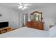 This bedroom boasts light gray walls, wood furnishings, and soft natural lighting at 416 River Forest Dr, Mcdonough, GA 30252