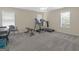 Spacious bonus room offers home gym equipment and multiple windows at 416 River Forest Dr, Mcdonough, GA 30252