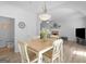 Open dining area with wood-look floors, neutral paint, and views into the living room at 416 River Forest Dr, Mcdonough, GA 30252