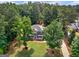 Inviting two-story home with lush green lawn and mature trees offering curb appeal and shade at 416 River Forest Dr, Mcdonough, GA 30252