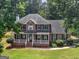 Aerial view of a two story red brick home with a large front yard and well maintained landscape at 416 River Forest Dr, Mcdonough, GA 30252