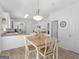 Kitchen features white cabinets, stainless appliances, wood-look laminate floors, and pendant lighting at 416 River Forest Dr, Mcdonough, GA 30252
