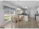 Eat-in kitchen features stainless steel appliances, white cabinetry, and wood-look laminate flooring at 416 River Forest Dr, Mcdonough, GA 30252