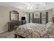 Large main bedroom with a tray ceiling, dark furniture, and windows allowing natural light at 416 River Forest Dr, Mcdonough, GA 30252