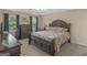 Spacious bedroom featuring a tray ceiling, dark wood furniture, and two windows offering natural light at 416 River Forest Dr, Mcdonough, GA 30252