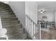 Carpeted staircase with white wood railing leads to the home's upper level at 416 River Forest Dr, Mcdonough, GA 30252
