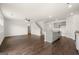 Open-concept living room featuring hardwood floors, a kitchen island, and staircase at 631 Whitman Ln, Stockbridge, GA 30281
