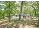 View of the back exterior featuring a fenced-in yard and white brick with dark trim at 3833 Bakers Ferry Sw Rd, Atlanta, GA 30331